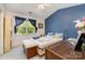 Cozy bedroom with natural light and blue accent wall at 7504 Petrea Ln, Charlotte, NC 28227
