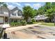 A well-maintained townhome with assigned parking, green landscaping, and a traditional exterior at 7504 Petrea Ln, Charlotte, NC 28227