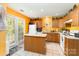 Bright kitchen with yellow walls, island, and white appliances at 7504 Petrea Ln, Charlotte, NC 28227