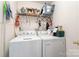 Functional laundry room with appliances and wire shelving for storage convenience at 7504 Petrea Ln, Charlotte, NC 28227