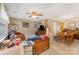 Living area with carpet, ceiling fan, and stairs leading to the second floor at 7504 Petrea Ln, Charlotte, NC 28227