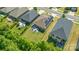 This aerial view shows a home with a spacious backyard, patio, and solar panels, surrounded by mature trees at 7530 Porrera St, Charlotte, NC 28214