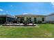 Lush backyard features patio with outdoor kitchen, seating, and well-maintained lawn at 7530 Porrera St, Charlotte, NC 28214