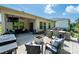 Expansive backyard with outdoor kitchen, dining area, covered seating, and lush trees at 7530 Porrera St, Charlotte, NC 28214