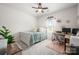 Bright bedroom with a ceiling fan, desk, plush rug, natural light, and stylish decor at 7530 Porrera St, Charlotte, NC 28214