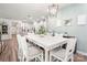 Bright dining room with a white table, gray cushioned chairs, and modern pendant lighting at 7530 Porrera St, Charlotte, NC 28214