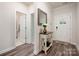Welcoming entryway with sleek flooring, hallway mirror, foyer table, and access to nearby rooms at 7530 Porrera St, Charlotte, NC 28214