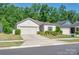 Charming single-Gathering home boasts a well-manicured lawn, two-car garage, and beautiful landscaping at 7530 Porrera St, Charlotte, NC 28214