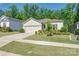Charming single-story home with a well-manicured lawn, lush landscaping, and attached two car garage at 7530 Porrera St, Charlotte, NC 28214