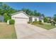 Well-maintained single-story home featuring an attached two-car garage and beautifully landscaped front yard at 7530 Porrera St, Charlotte, NC 28214