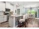 Open concept kitchen with a center island, pendant lighting, and a view to the dining area at 7530 Porrera St, Charlotte, NC 28214