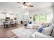 Bright, open-concept living room with hardwood floors, modern furnishings, and a seamless flow to the kitchen at 7530 Porrera St, Charlotte, NC 28214