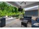Relaxing covered patio with outdoor seating, ceiling fan, and mounted television at 7530 Porrera St, Charlotte, NC 28214