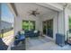 Inviting covered patio with comfortable seating and a ceiling fan, perfect for relaxation at 7530 Porrera St, Charlotte, NC 28214