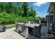Outdoor patio featuring a dining table set with seating surrounded by trees and a lush lawn at 7530 Porrera St, Charlotte, NC 28214