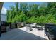 Comfortable outdoor patio with seating area, wood burning fire pit, and grill at 7530 Porrera St, Charlotte, NC 28214