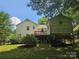 Backyard showcasing a deck and lush greenery at 7608 Surreywood Pl, Charlotte, NC 28270
