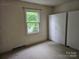 Bedroom featuring window offering natural light and a built-in wardrobe at 7608 Surreywood Pl, Charlotte, NC 28270
