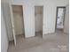 Bedroom with closet spaces, offering ample storage and functionality, and featuring carpeted floors at 7608 Surreywood Pl, Charlotte, NC 28270