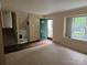 Inviting living room features a bright window, neutral walls, and hardwood floors with staircase nearby at 7608 Surreywood Pl, Charlotte, NC 28270