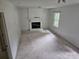 Cozy living room featuring a painted brick fireplace, wood-paneled walls, and a sunny window at 7608 Surreywood Pl, Charlotte, NC 28270