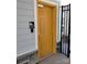 Exterior women's bathroom with yellow door and stone accents provides a convenient community amenity at 8406 Flint Hill Dr, Charlotte, NC 28273