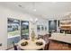 Bright dining area adjacent to the living room with backyard views and stylish chandelier at 8406 Flint Hill Dr, Charlotte, NC 28273