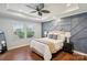 Main bedroom featuring an accent wall, trey ceiling, bedside tables, and hardwood floors at 8406 Flint Hill Dr, Charlotte, NC 28273