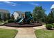 A vibrant green playground with slides and climbing structures set in a well-maintained communal area at 8406 Flint Hill Dr, Charlotte, NC 28273