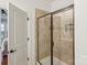 Shower with glass doors and a tile surround at 8406 Flint Hill Dr, Charlotte, NC 28273