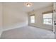 Neutral bedroom showcasing two windows and plush carpeting, offering a serene and comfortable space at 8493 Twickenham Ter, Harrisburg, NC 28075