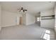 Expansive bonus room featuring neutral carpeting, a ceiling fan, and natural light, offering versatile space at 8493 Twickenham Ter, Harrisburg, NC 28075