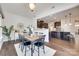 Dining room showcasing open layout and access to a modern kitchen with dark cabinets at 8493 Twickenham Ter, Harrisburg, NC 28075
