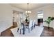 Formal dining room featuring wainscoting, a chandelier, and hardwood floors at 8493 Twickenham Ter, Harrisburg, NC 28075