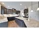Spacious kitchen with stainless steel appliances, granite countertops, and dark wood cabinets at 8493 Twickenham Ter, Harrisburg, NC 28075