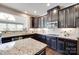 Stylish kitchen with dark wood cabinets, granite countertops, and stainless steel appliances at 8493 Twickenham Ter, Harrisburg, NC 28075