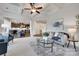 Inviting living room featuring coffered ceiling, open to modern kitchen with bar seating and stylish decor at 8493 Twickenham Ter, Harrisburg, NC 28075