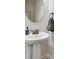 Stylish powder room featuring a pedestal sink and modern fixtures at 8493 Twickenham Ter, Harrisburg, NC 28075