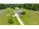 Aerial view of a beautiful home with an attached two-car garage, complemented by an expansive lawn at 8717 Swift Rd, Oakboro, NC 28129