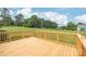 Inviting wood deck overlooking a large grassy yard with mature trees at 8717 Swift Rd, Oakboro, NC 28129