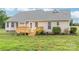 Exterior view of the home features a wooden deck and spacious backyard at 8717 Swift Rd, Oakboro, NC 28129