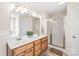 Bathroom features double sinks and a glass enclosed shower at 8717 Swift Rd, Oakboro, NC 28129