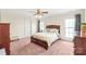 Cozy bedroom with neutral walls, plush carpeting and a ceiling fan at 8717 Swift Rd, Oakboro, NC 28129