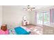 Bright bedroom featuring carpet, window, and a white vanity table with mirror at 8717 Swift Rd, Oakboro, NC 28129