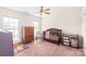 Cozy carpeted bedroom with a wood crib, chair, and chest of drawers at 8717 Swift Rd, Oakboro, NC 28129