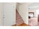 Inviting entryway with carpet stairs, hardwood floor and view into main bedroom at 8717 Swift Rd, Oakboro, NC 28129