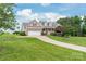 Charming home featuring a manicured front lawn, a long driveway, and a two-car garage at 8717 Swift Rd, Oakboro, NC 28129