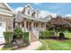 Inviting front porch with brick and column detailing, offering a warm entrance to the home at 8717 Swift Rd, Oakboro, NC 28129