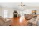 Spacious living room featuring hardwood floors, a fireplace, and a ceiling fan at 8717 Swift Rd, Oakboro, NC 28129