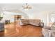 Open floor plan living room showcasing hardwood floors and a connection to the kitchen area at 8717 Swift Rd, Oakboro, NC 28129